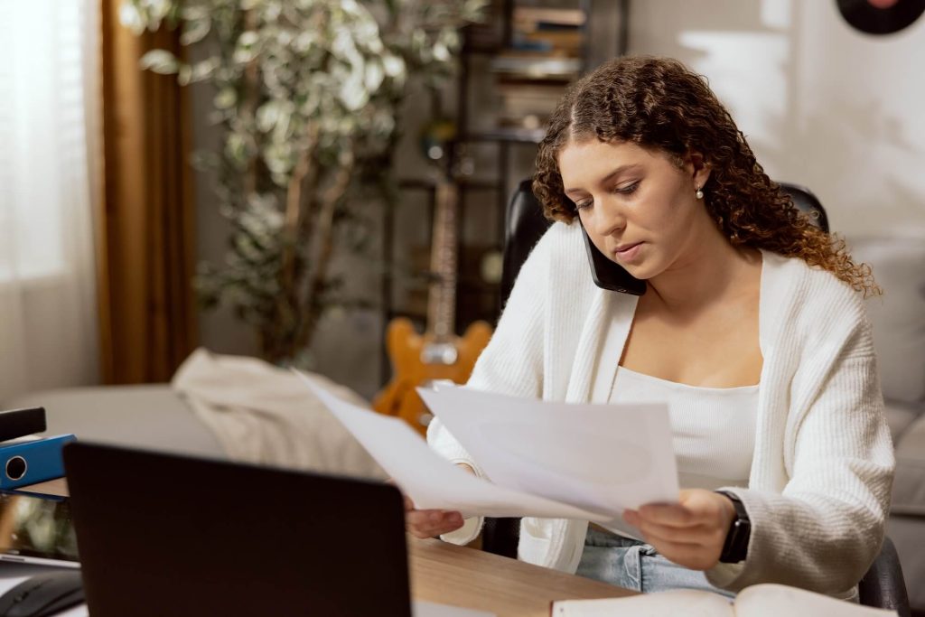 A woman looks at the papers for filing for divorce and thinks about the cost of this service.